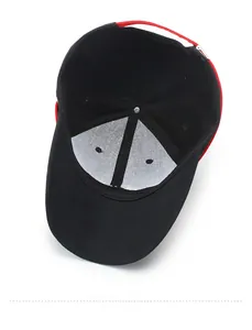 Internal view of a black baseball cap with red strap showing lining and stitching details