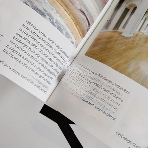 Polished minimalist 925 sterling silver open ring shown on a stylish lifestyle book background
