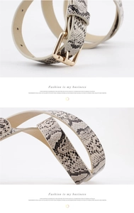 Detail of vintage snake print women's belt with a polished gold-tone metal pin buckle