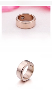 Detail of 8mm rose gold stainless steel ring featuring inlaid magnetic stones for wellness