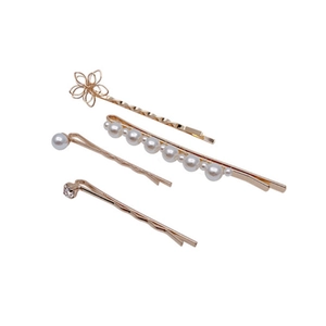 Golden geometric hair clip set with faux pearls and rhinestones on a white background