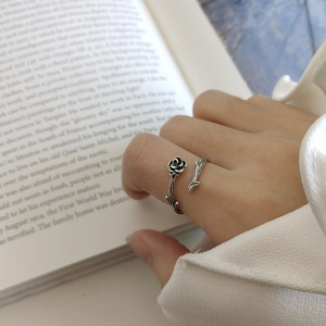 Vintage 925 sterling silver rose thorn open ring with oxidized finish worn by a model