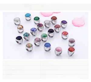 Close-up of assorted stainless steel rings with colorful opal and turquoise stone inlays