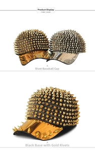 Detail view of gold and silver sharp metal spikes on punk style black baseball caps