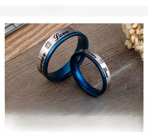 Detail of blue titanium couple ring with Love Forever engraving and sparkling zircon stone