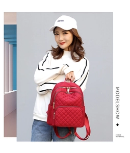 Red quilted nylon backpack for women featuring gold-tone zippers and stylish diamond pattern