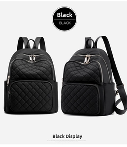 Detail of black nylon backpack featuring quilted diamond pattern and gold-tone hardware