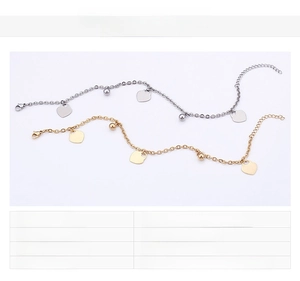 Detail of 18K gold plated stainless steel anklet with heart charm and bead accents