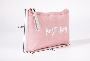 Close-up detail of pink canvas cosmetic bag with dimensions 17x11x3cm, portable zipper pouch.