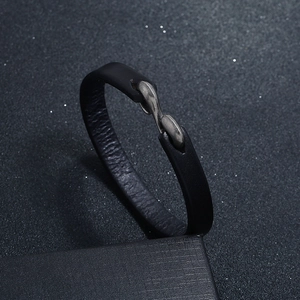 Detailed view of black genuine leather bracelet with antique metal S-hook on gift box