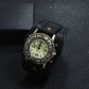 Close-up of vintage leather watch featuring an antique bronze compass dial and quartz movement