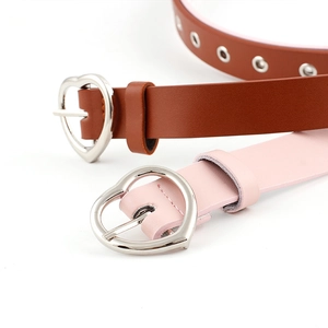 Brown and pink leather belts featuring heart-shaped metal buckles and decorative eyelets