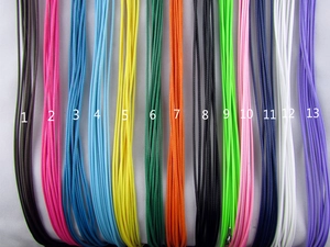 Close-up of DIY necklace cord assortment showing thirteen vibrant braided wax rope colors