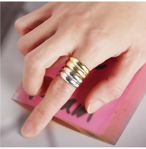 Close-up of minimalist double layer wide bands in polished gold and silver finishes