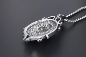 Detail view of punk skull helm pendant in silver stainless steel with box chain