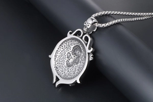 Macro shot of a punk retro skull and rudder pendant in vintage silver titanium steel