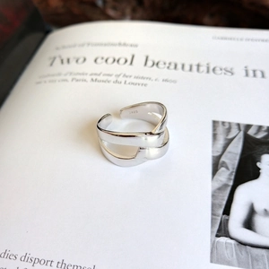 Detail view of the S925 sterling silver stamp on a minimalist knotted cross ring