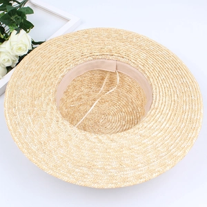 Flat top natural straw hat with wide brim showing inner sweatband and adjustable cord