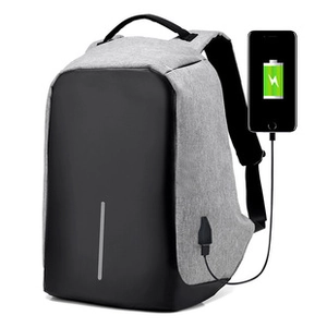 Detail of grey and black anti-theft backpack with side USB charging port and phone connection