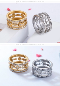 Detail view of gold and silver hollow star rings featuring sparkling zircon stones