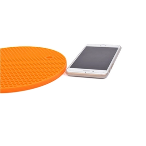 Orange honeycomb silicone trivet mat for hot pots with a round non-slip surface