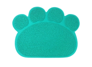 Close-up of green PVC coil pet mat in paw shape with non-slip texture for litter trapping