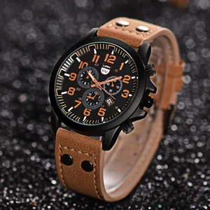 Detail of men's military watch with brown leather strap and black matte case with orange numerals