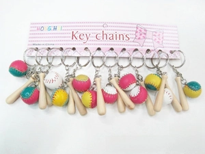 Close-up of mini wooden baseball bat keychain sets in pink, white, and yellow colors
