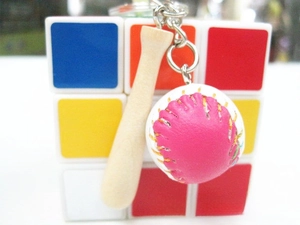 Close-up of mini baseball bat and ball keychain accessory on metal ring for sports gifts