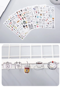 Close-up of watercolor travel stickers featuring food and lifestyle themes for DIY journals