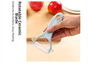 Close-up of Y-shaped vegetable peeler with rotatable ceramic blade in use on an apple