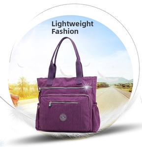 Detail of purple nylon shoulder bag showing multiple zipper pockets and brand logo