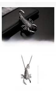 Detailed macro view of a large stainless steel scorpion pendant with punk textures