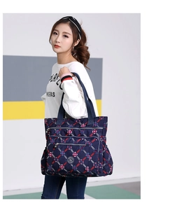 Detailed side view of nylon tote bag with blue and red geometric diamond pattern