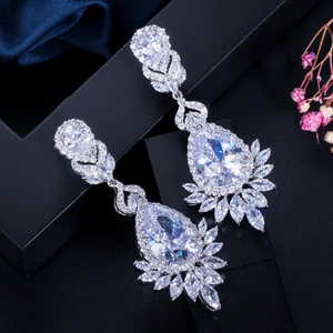 Macro detail of tear drop AAA cubic zirconia drop earrings on a velvet display