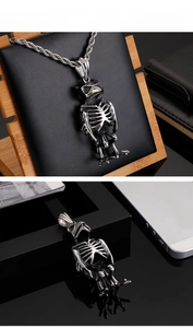 Close-up of gothic owl skeleton pendant made of stainless steel with intricate bone details