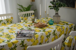 Detail of waterproof lemon print tablecloth and matching chair covers in cozy dining room