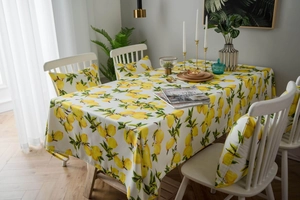 Close-up of fresh lemon print tablecloth and matching chair cushion in a sunlit room