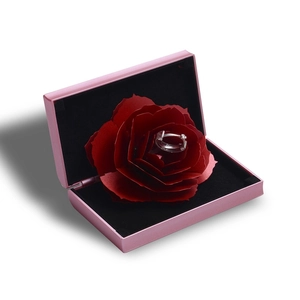 Creative pink rotating rose jewelry box with silver diamond ring and red floral detail