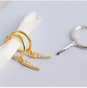 Close-up of gold s925 silver hoop earrings with diamond-encrusted triangle pendants