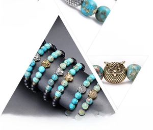 Detail view of natural stone bead bracelets with lion, leopard and owl animal charms