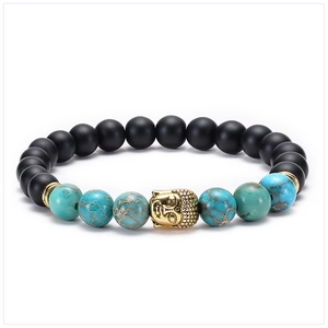 Detailed shot of black matte beads and blue emperor stone bracelet with golden Buddha head