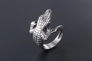 Close-up of vintage silver crocodile ring with realistic scale texture and gothic details