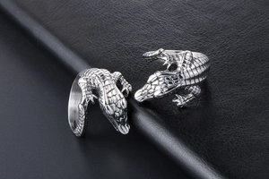 Macro shot of silver vintage crocodile open ring showing detailed scales on black leather