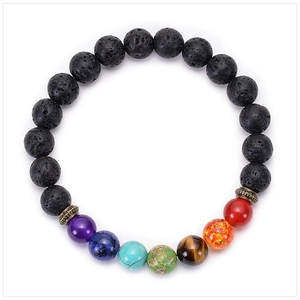 Detailed macro view of 7 chakra natural stone beads and porous black lava rock bracelet