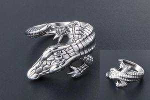 Detailed close-up showing intricate crocodile scales on a vintage silver textured ring