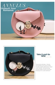 Detail of embroidered faux leather mini coin pouch with gold metal lock in pink and black