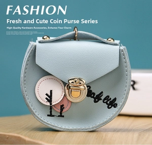 Detail of light blue faux leather coin purse with 'Life' embroidery and gold twist lock
