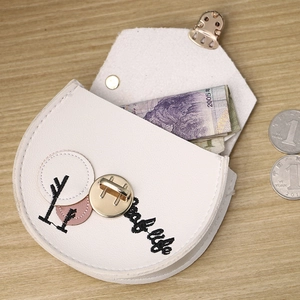 Detailed view of an open white PU leather coin purse with golden metal twist lock and embroidery