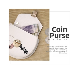 Detail of white PU leather semi-circular coin purse with gold clasp and embroidery
